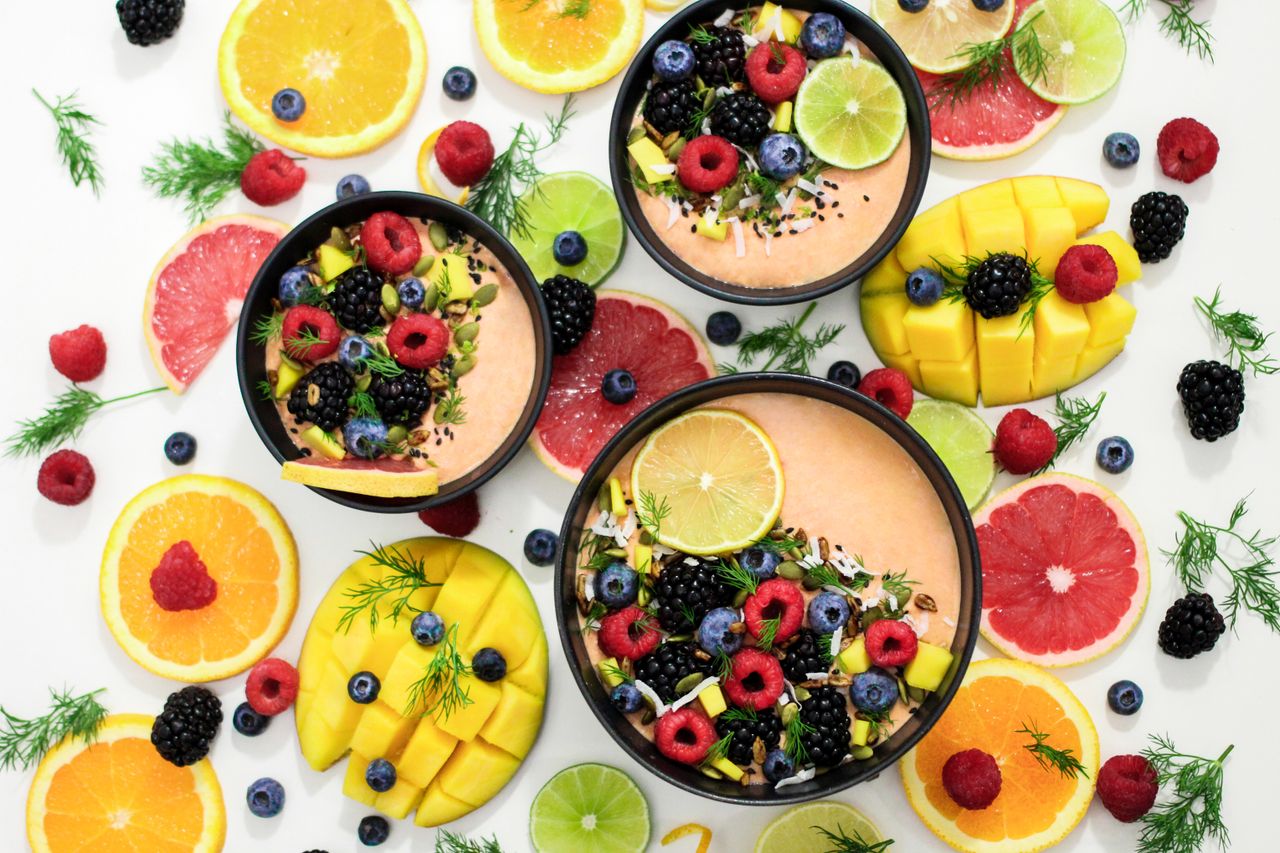 approach-img A colorful assortment of fresh fruit bowls featuring mixed berries and citrus slices, perfect for healthy eating inspiration.